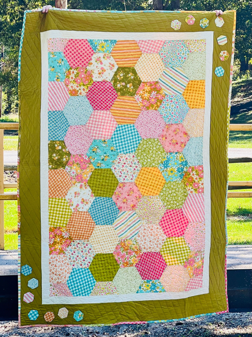 This is a one of a kind handmade quilt featuring some bright and fun high quality quilting cotton fabrics. The finished quilt is 78 1/2" x 54" which is perfect for a throw blanket on the couch or on a full size bed.